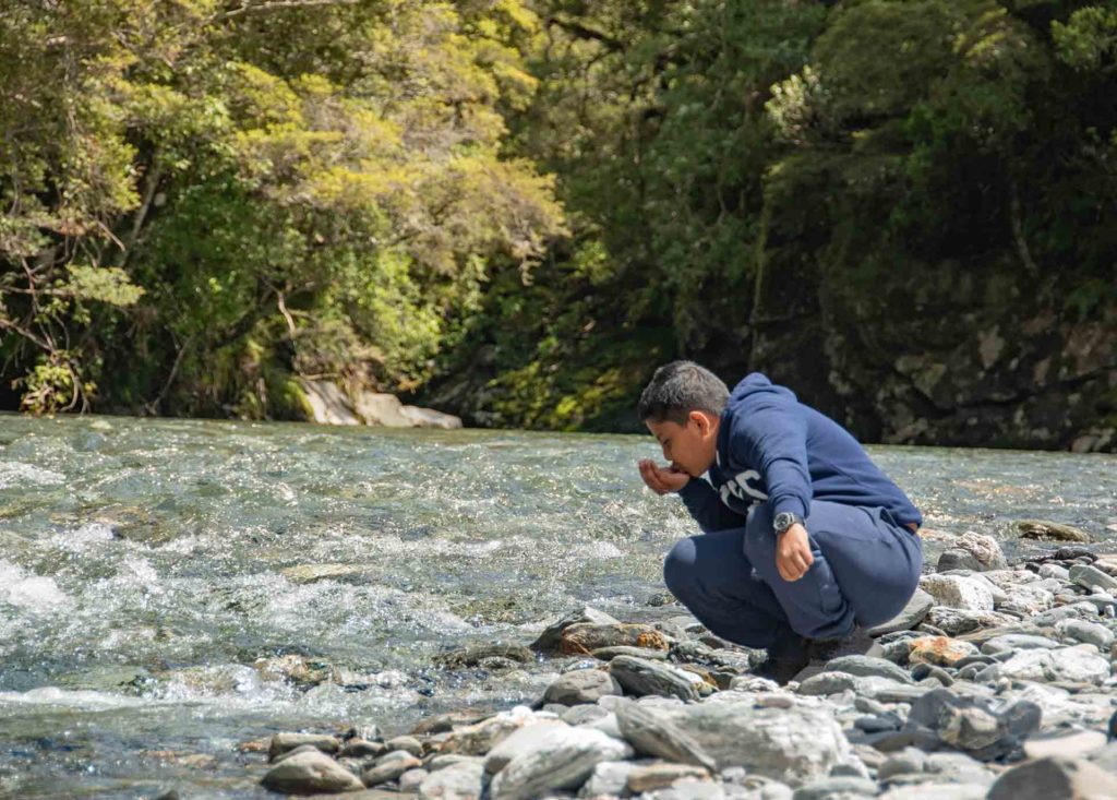 A person standing on a rock

Description automatically generated