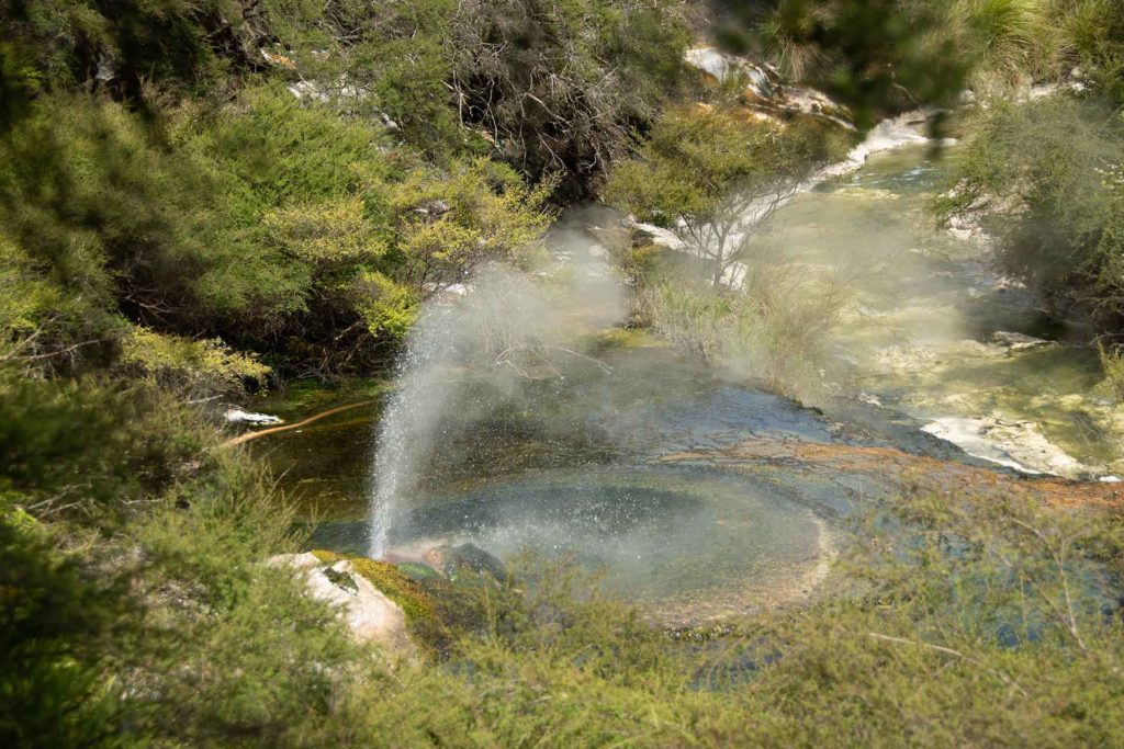 A waterfall going over a body of water

Description automatically generated